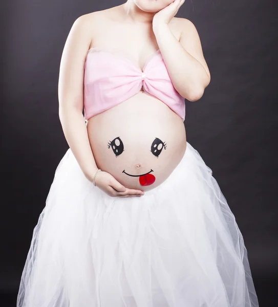 Беременная мать в черном фоне — стоковое фото