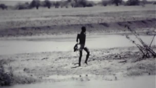 African Fisherman Crosses River - Vintage 8mm — Stock Video