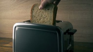 Kahverengi ekmek tost makinesine konur ve çıkar.