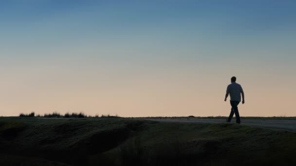 Man Walks Away Along Horizon