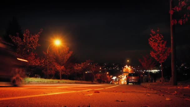 Coches conducen colina abajo en la ciudad por la noche — Vídeos de Stock