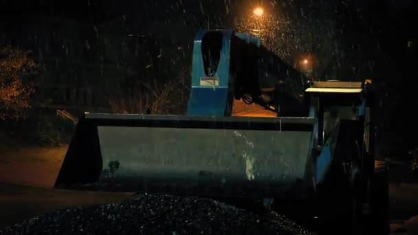 Nieve cayendo en la máquina excavadora en la noche — Vídeo de stock