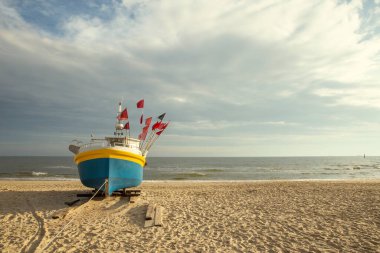Fishing boat on the beach at Baltic sea, Poland clipart