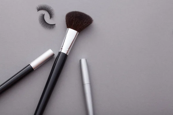 Beautiful makeup on a gray background. — Stock Photo, Image