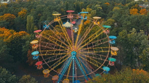 Ferris wheel attraction in the park in autumn from a height.