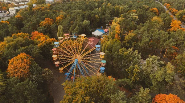 Ferris wheel attraction in the park in autumn from a height.