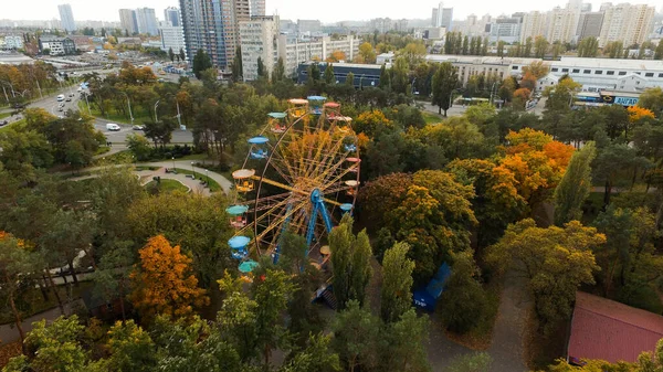 Ferris wheel attraction in the park in autumn from a height.