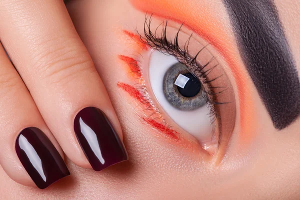 Eye makeup and manicure.