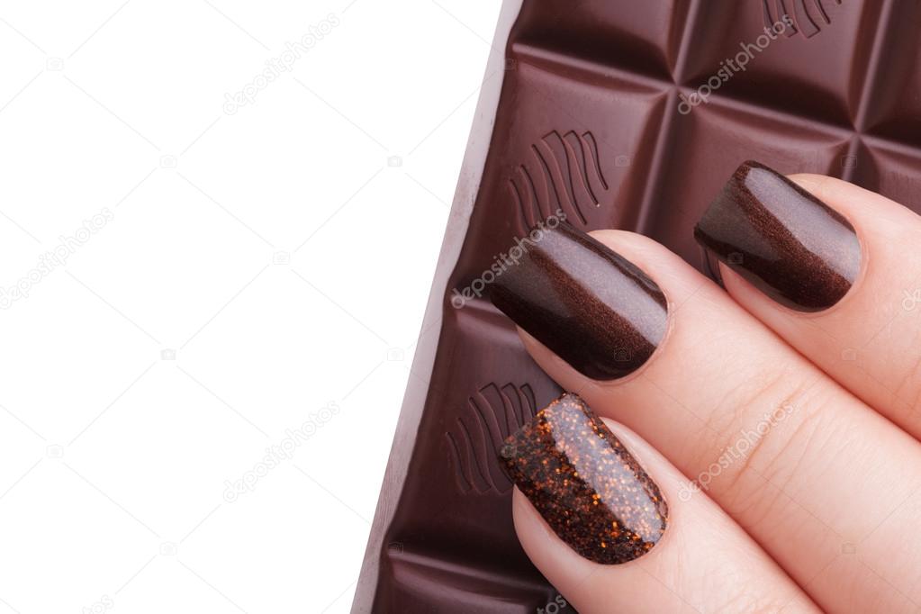 Brown nail polish on the nails.