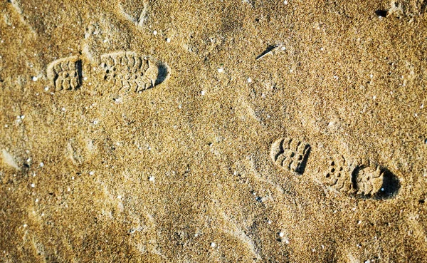 Sporen van menselijke schoenen in het zand — Stockfoto