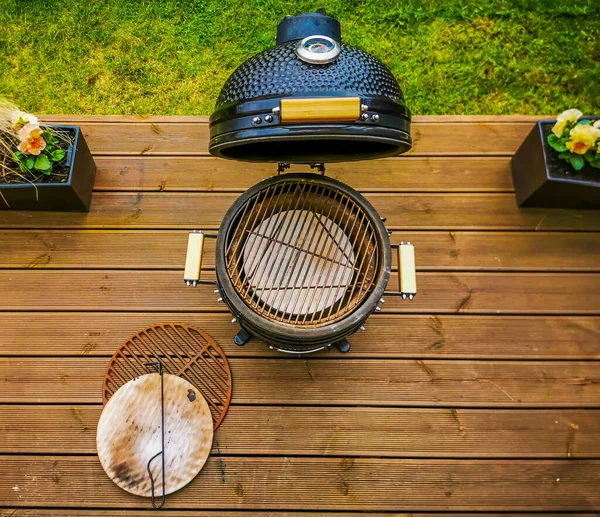 Ev terasında aksesuarları olan bir barbekü ızgarası..
