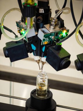 Perfume production. Different scents in bottles. Robotic perfume production line with automated fragrance dispensing 