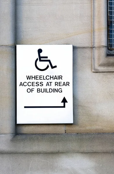 Disabled accessible push button buzzer for assistance sign at building entrance — Stock Photo, Image