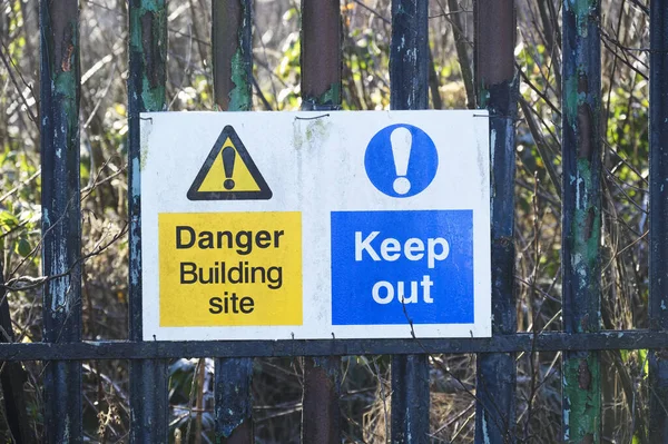 Construction site health and safety keep out sign on fence boundary