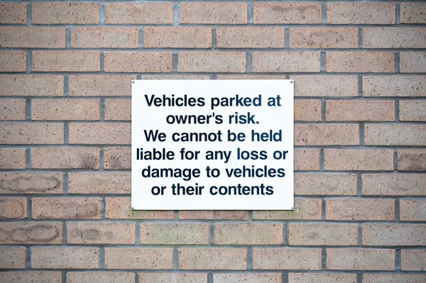 Car park users do so at own risk sign