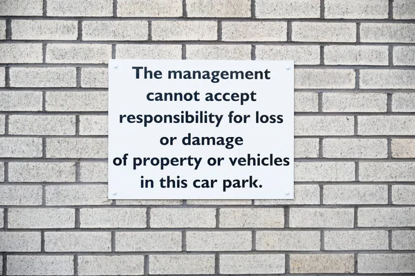 Car park users do so at own risk sign