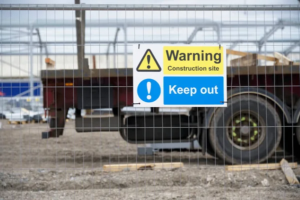 Construction site health and safety message rules sign board signage on fence boundary