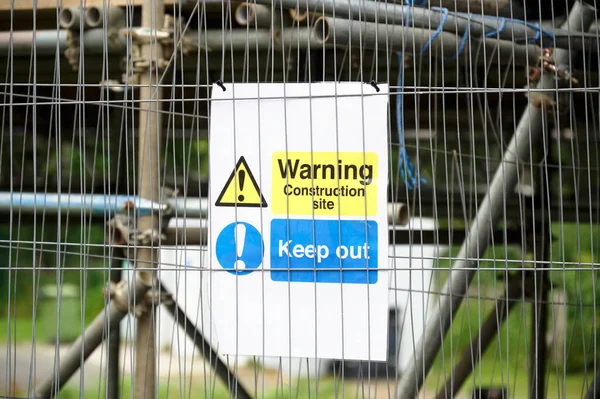 Construction site health and safety message rules sign board signage on fence boundary