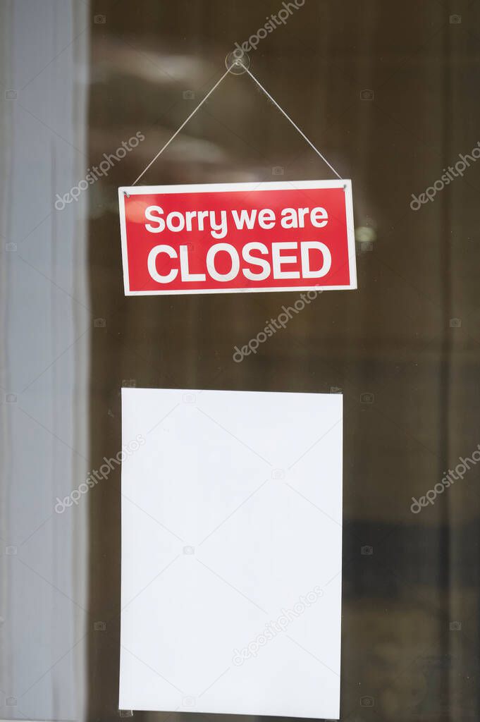 Sorry we are closed sign on shop door window