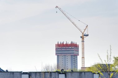 Tower cranes high in sky at construction site UK