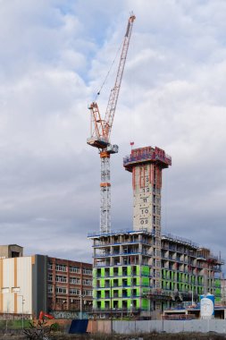Tower cranes high in sky at construction site UK