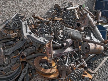 Fly tipping of old car engine parts left outside garage UK