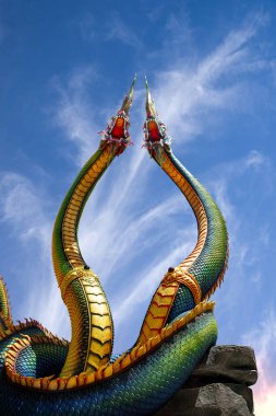 Udon Thani, Thailand - 21 June 2021 : Low angle view of Twin Stucco painted as a large serpent with beautiful sky at Pra kai keaw-wang nakin, Located at Ban Don swan, Phen District, Udon Thani, Thailand