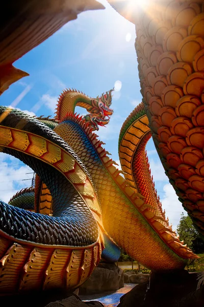 Udon Thani, Thailand - 21 June 2021 : Low angle view of Twin Stucco painted as a large serpent with beautiful sky at Pra kai keaw-wang nakin, Located at Ban Don swan, Phen District, Udon Thani, Thailand