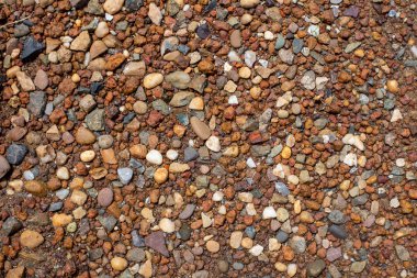 Toprakta renkli taşlar ve çakıl taşları, enkaz ve çakıl taşlarıyla dolu üst manzara. Doku veya arkaplan kullanmak için ideal
