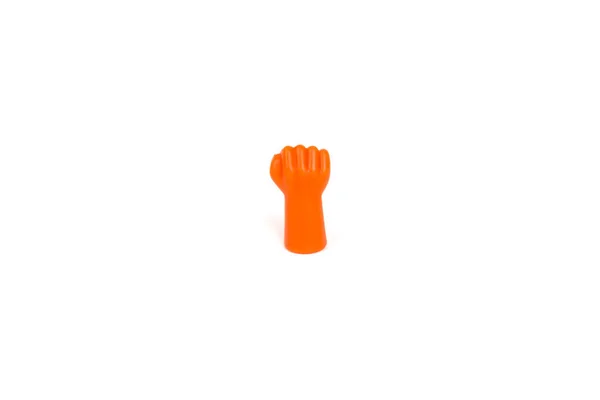 Orange plastic hand with fist isolated on white background. Protest concept — Stock Photo, Image