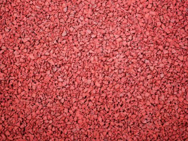 Oyun alanı için esnek kırmızı fayans. Plastik kırıntıların karışımından yapılmış fayanslar..