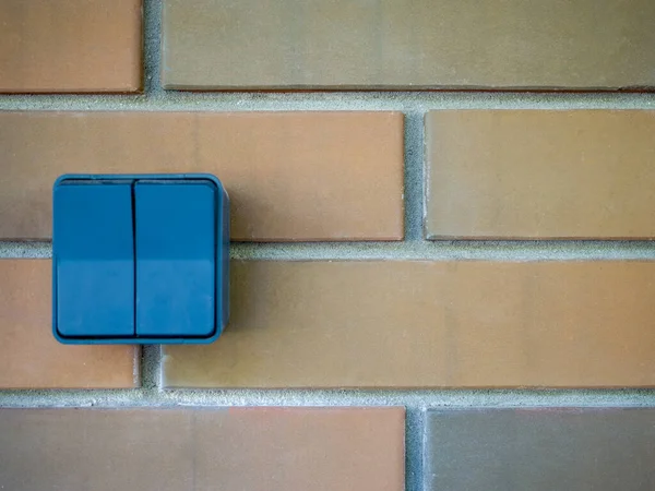 Double gray street light switch on a brick wall. — Stock Photo, Image
