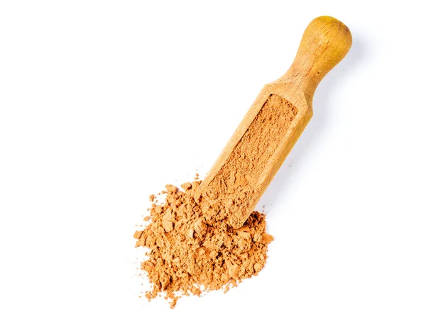 Close-up of cocoa powder lying in a wooden scoop. Top view. — Stock Photo, Image