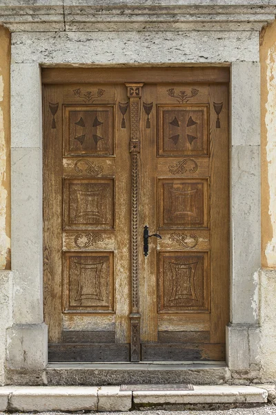 Old and restored wooden church door — Stock Photo, Image