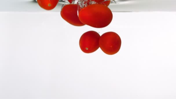 Cherry tomatoes through water — Stock Video