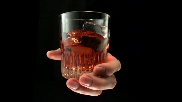 Hand stirring glass of drink — Stock Video