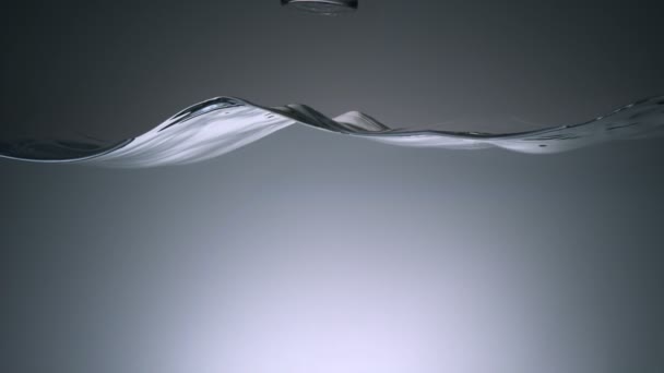 Water surface wave and glass falling — Stock Video