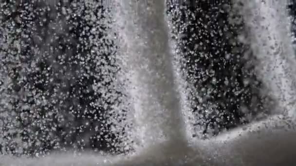 Pile of sugar on black background shooting with high speed — Stock Video