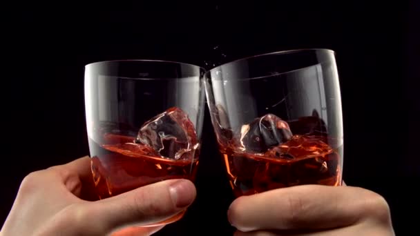 Two glasses of whiskey toasting — Stock Video