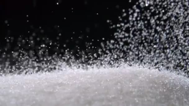 Stapel van suiker op zwarte achtergrond schieten met hoge snelheid — Stockvideo