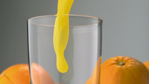 Pouring orange juice into glass — Stock Video