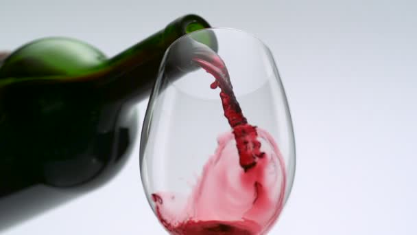 Pouring red wine into glass — Stock Video