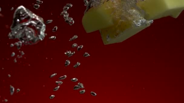 Potato pieces falling in water — Stock Video