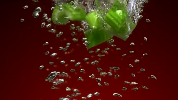 Celery pieces falling in water — Stock Video