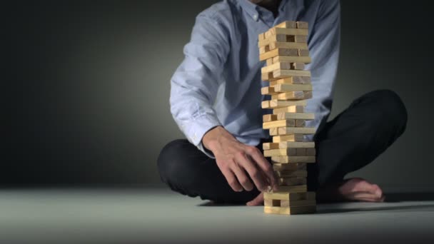 Person collapsing block tower — Stock Video