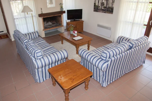 Blue striped sofa in a living room at home — Stock Photo, Image