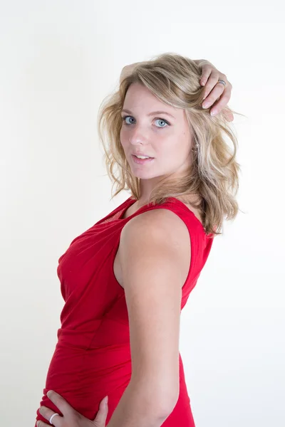 Young Beautiful woman wearing a red dress isolated on a white background — Stock Photo, Image