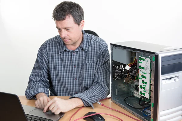 Computer engineer working on broken console in his office