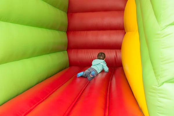 Young boy playing in inflatable playground — Stock Photo, Image