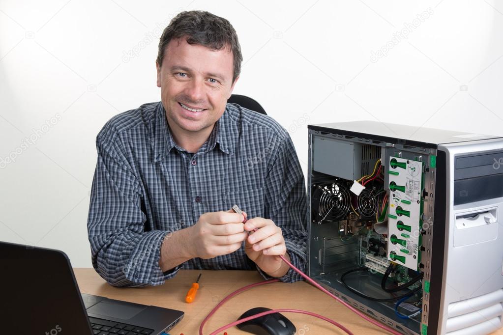 Brunette IT specialist installing ram memory at work